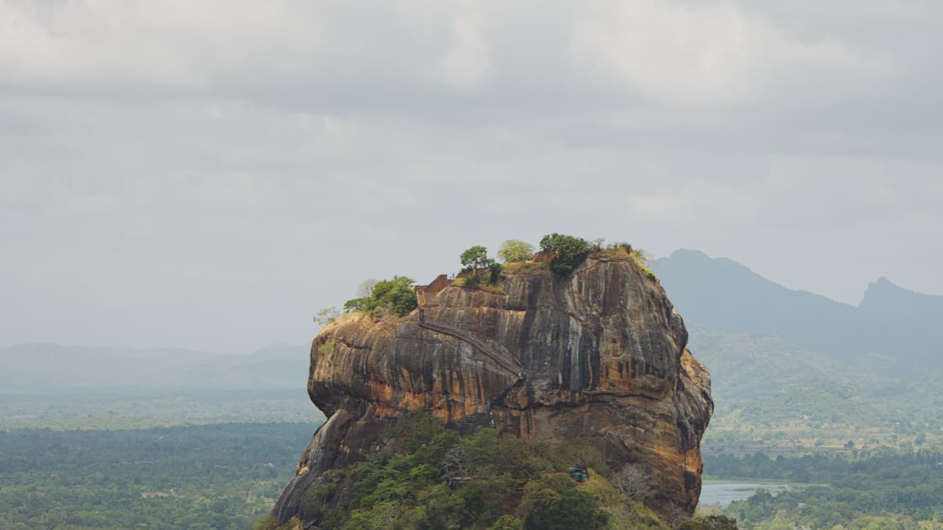 Sigiriya Rock Fortress rising out of the jungle plain at first light