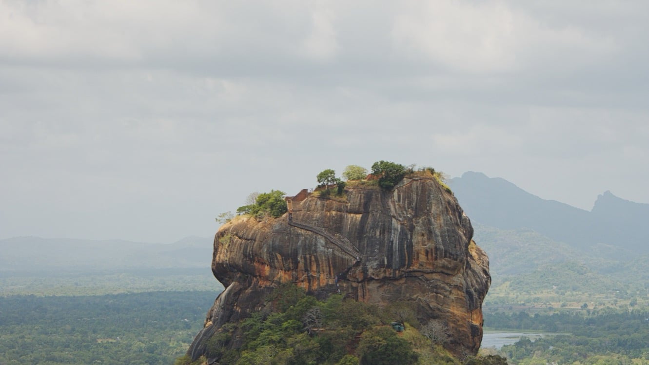 Sigiriya Rock Fortress rising out of the jungle plain at first light